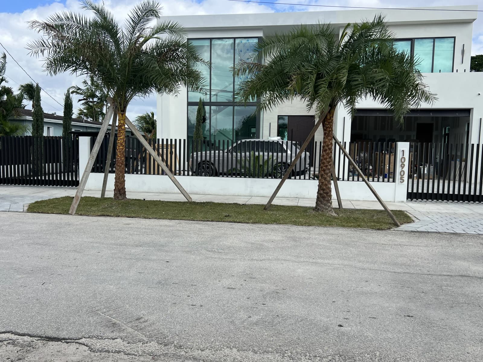 Modern black aluminum slat fence in front of a contemporary Miami home