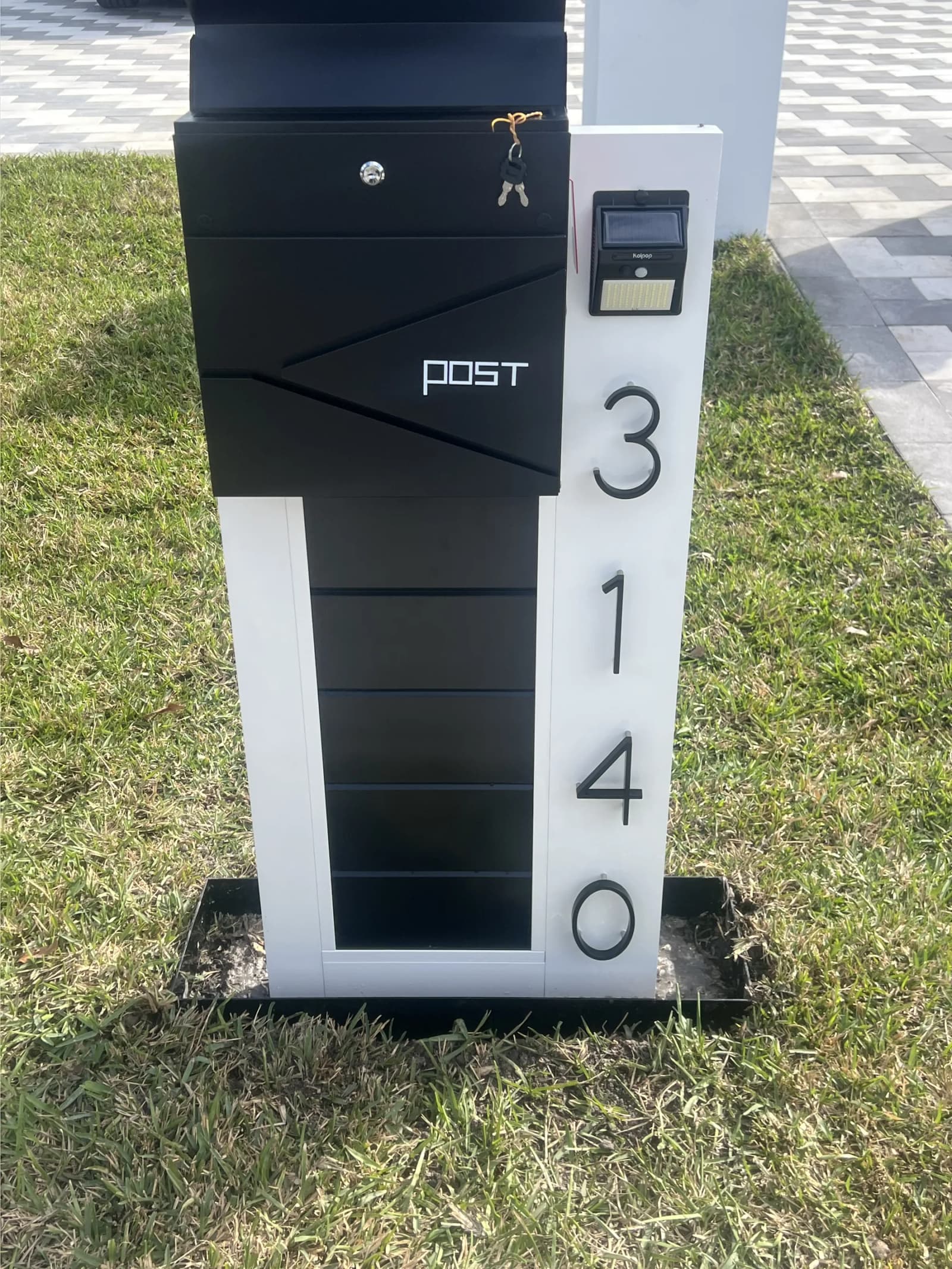 Custom fabricated aluminum mailbox post with house numbers